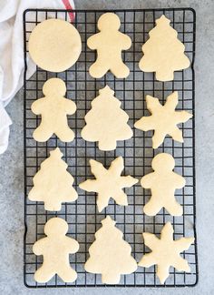 cut out cookies on a cooling rack ready to be decorated with icing and decorations