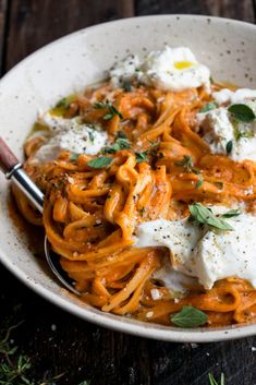 a white bowl filled with pasta and cheese