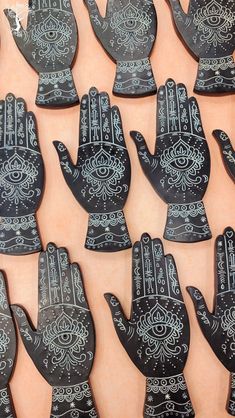 many black and white hand shaped magnets with designs on them