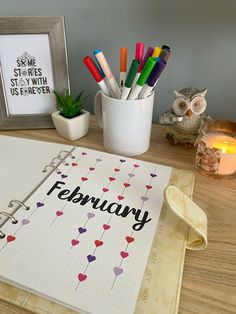 an open planner sitting on top of a wooden table