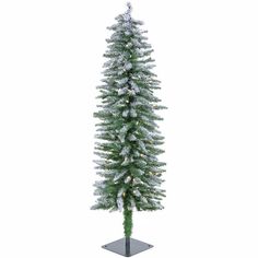 a tall white christmas tree with snow on it's branches and the top half covered in