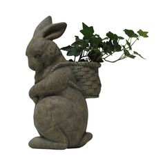 a statue of a rabbit holding a basket with plants in it