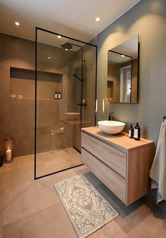 a bathroom with a sink, mirror and shower stall in it's own area