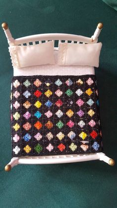 a crocheted bed frame with buttons on the top and bottom is made out of fabric