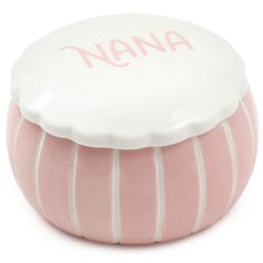 a pink and white ceramic container with the word nana on it's lid