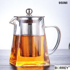 a glass tea pot filled with green tea