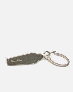 a metal keychain with a bottle opener attached to it's back end