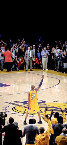 the basketball player is celebrating his team's win in front of an excited crowd