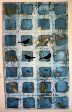 a piece of art with birds sitting on it's squares in blue and white