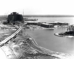 an old black and white photo of a construction site in the middle of a body of water