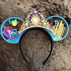 a mickey mouse ears headband with an image of disney's musical instruments on it