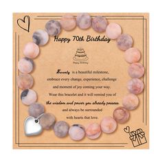 a happy birthday card with a bracelet made out of stones and a heart shaped charm