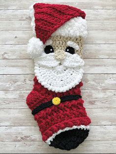 a crocheted christmas stocking with a santa clause on it's face