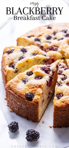 a close up of a cake on a plate with berries and blackberries around it