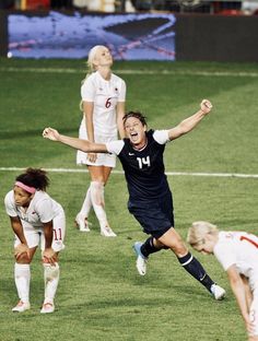 two women are playing soccer on the field