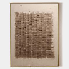 an abstract painting with squares and lines in brown on a white wall above a wooden frame