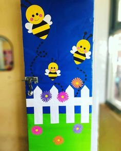 the door is decorated with bees and flowers