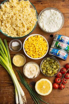 the ingredients for this pasta dish are laid out on top of a wooden table, ready to be eaten