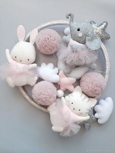 a basket filled with stuffed animals on top of a white table next to a gray wall