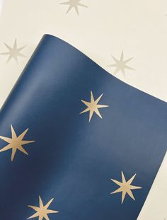 a blue and white wall with gold stars on it