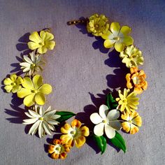 Vintage Sandor Enamel Flower Necklace Lei. 1950's, collectible, iconic Sandor wreath of flowers necklace featuring a variety of blooms from pansies to daisies. Fabulous color palette of orange, yellow and white. Each flower is different. Some meticulously outlined in gold. All linked together to form a spectacular lei. Bright enamel on metal. 18" long by 2&1/2" at its widest. Signed Sandor on the hook clasp. Excellent vintage condition with only a few very minor pocks or nicks. Utterly stunning! Customised Birthday Gifts, Book Locket, Pansies Flowers, Statement Choker, Statement Choker Necklace, Long Chain Necklace, Personalized Candles, Cat Necklace, Enamel Flower