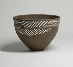 a black and white bowl sitting on top of a table