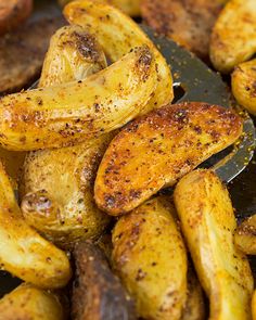 some fried potatoes are being cooked in a skillet