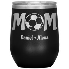 a black wine glass with the word mom and soccer ball on it's side