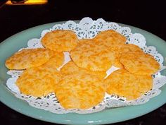 some fried food is on a blue plate with white doily and black table cloth