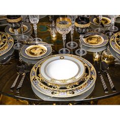 the table is set with gold and silver plates