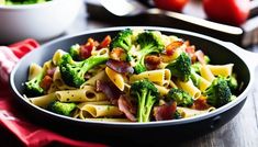 a bowl full of pasta with bacon and broccoli