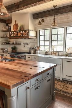 a kitchen with an island in the middle and lots of counter space on one side