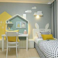 a child's bedroom decorated in yellow and gray with a bed, desk, chair, and toy house