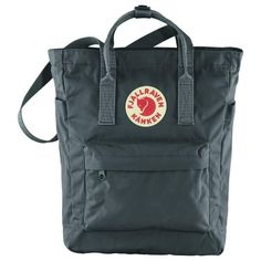 Fjallraven F23710031 Kanken Totepack -Graphite, One Size. The Fjallraven Kanken Totepack is a lightweight day bag made for grab-and-go convenience. The main zippered compartment holds all the daily essentials, including an extra layer, lunch, and even a 13" laptop or tablet. The zippered pocket on the front keeps your smaller accessories organized, and the side pockets can hang onto a small umbrella or water bottle. Carry it like a tote, shoulder bag, or backpack, whatever suits the moment. Can Fjallraven Kanken Totepack, Kanken Totepack, Fjällräven Kånken, Small Umbrella, Classic Bags, Day Bag, Rei Co-op, Kanken Backpack, Small Accessories