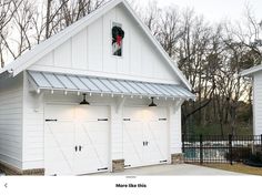 two white garages with lights on the roof and one has a red traffic light