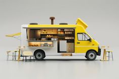 a yellow and white food truck parked on top of a gray floor next to tables