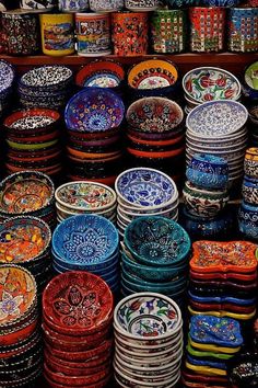 many colorful bowls are stacked on top of each other