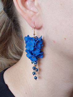 https://purplebeestudio.etsy.com Handmade polymer clay very delicate chandelier earrings. The delicate flowers are made by hand by me without using any molds. These elegant earrings in trendy cobalt blue colour will become your favorits for many occasions day or night.  Perfect gift for a special woman in your life. Earrings made with brass ear wire. The earrings are very light and comfortable to wear all day. SHIPPING: Your order will be dispatched in a securely packed cardboard box. Product ca Blue Dangle Flower Earrings In Polymer Clay, Elegant Blue Polymer Clay Earrings, Delicate Chandelier, Blue Flower Earrings, Cobalt Blue Earrings, Handmade Flower, Flower Jewelry, Earrings Long, Delicate Flower