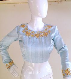 Pure sky blue raw silk blouse with gota patti work . Work is done in gold gota leaves, sequins and gold metallic thread.Custom fitted. -Measurements sheet will be sent to you once you order( Standard sizing also available) -Custom colors available -Work on front, back and sleeves. Please convo me if you're have any specific requirements. This blouse can be done with or without the bust cup inserts . The blouse is fully lined is cotton. Usual turn around time is 1-2 weeks, but we may be able to a Fitted Light Blue Blouse For Wedding, Fitted Light Blue Blouse Piece With Zari Work, Blue Tops With Zari Work For Reception, Blue Zari Work Top For Wedding, Festive Light Blue Blouse Piece With Zari Work, Light Blue Unstitched Blouse Piece For Festivals, Light Blue Unstitched Blouse Piece For Festive Occasions, Traditional Light Blue Unstitched Blouse, Fitted Gold Blouse Piece With Gota Work