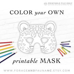 the printable mask is designed to look like a leopard's face with colored pencils around it