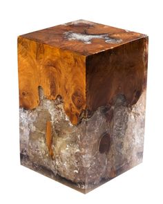 a wooden block sitting on top of a rock