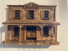 a wooden model of a building with windows and balconies on the outside wall