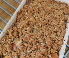 a casserole dish with apples and crumbled toppings on a cooling rack