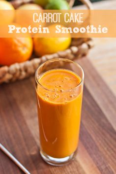 carrot cake protein smoothie in a glass on a cutting board next to oranges