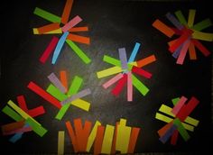 colorful pieces of paper are arranged in the shape of arrows on a black surface with white writing