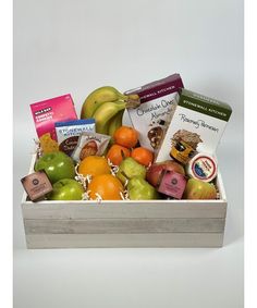 a wooden box filled with assorted fruit and snacks