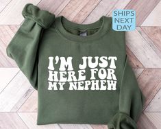 Im Just Here For My Nephew Sweatshirt, Gift For Aunt Hoodie, Cute Aunt Gift From Nephew, New Future Aunt Apparel, Funny Aunt Life Clothing ⭐ HOW TO ORDER ⭐ 1️⃣ Please check all the photos in the listing. 2️⃣ Choose your shirt size and color. (Please check listing photos for these) 3️⃣ In the personalization box, please enter your Text, Text Color, Text Style. 4️⃣ Click "Add to Cart". You can go back to the listing and follow the same steps to add more products. 5️⃣ Click "Proceed to Checkout". 6 Nephew Shirts, Auntie Life, Auntie Era, Aunt Sweatshirt, Aunt Life, Gift For Aunt, Hoodie Cute, My Nephew, 3rd Party