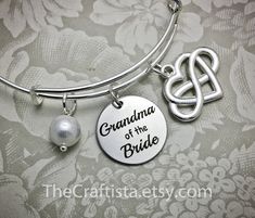 "♥ ✿ ♥ This elegant piece of jewelry will make a beautiful and sentimental gift that will best express your gratitude and love for your grandma. ♥ ✿ ♥ ✿ This piece includes ✿ ♥ disc pendant 20mm engraved with the words \"Grandma of the Bride\" ♥ infinity heart charm that symbolizes \"I love you forever\" ♥ authentic shell pearl (8mm) ♥ adjustable bangle 60mm in size (expandable to fit wrist 7-8\") ✿ Optional necklace (18-inch) OR keychain ✿ Leave a clear instruction at note to seller if you want Mother's Day Gift Bangle Jewelry For Mom, Mother's Day Bangle Gift For Mom, Mother's Day Gift Bangle Jewelry, Anniversary Charm Bangle Jewelry, Adjustable Bangle Jewelry Gift For Mom, Adjustable Hallmark Jewelry For Gifts, Mother's Day Gift Bracelet Jewelry For Mom, Mother's Day Bracelet Jewelry Gift For Mom, Mother's Day Gift Bracelet Jewelry