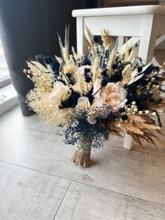 a bouquet of flowers sitting on top of a white chair