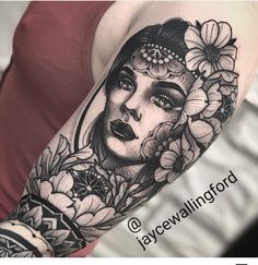 a woman's arm with flowers and a tattoo on her left arm, in black and white